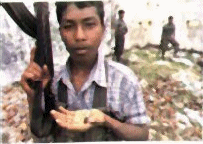 LTTE child soldier with a cyanide capsule in his hand
